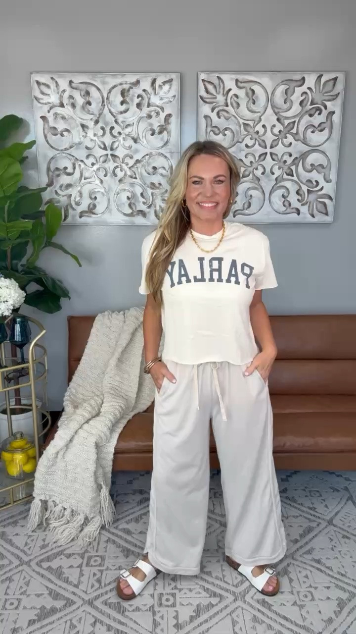 This is the kind of outfit I throw on when I want to be comfortable but still look put together. The graphic tee keeps it casual, the drawstring pants are lightweight with a relaxed fit, and the neutral colors make it easy to wear for travel days, errands, or working from home.

Graphic tee outfit, lounge pants, drawstring pants, travel outfit, casual everyday style, neutral outfit, comfortable fashion, airport outfit, relaxed fit pants, everyday basics, AudrieDollins

#LTKootd #LTKTravel #LTKSeasonal