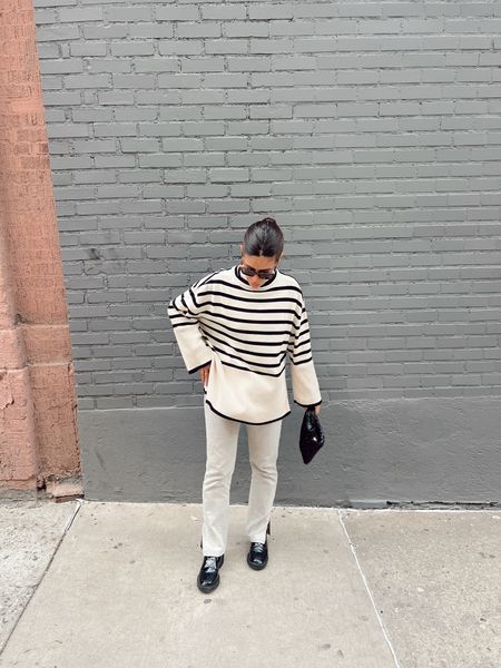 Casual neutral style - oversized stripe sweater with great jeans with a slit on the ankle and loafers!