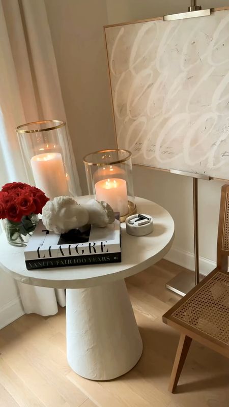 Kat Jamieson shares a corner of her living room. Hurricane lamp, candles, coffee table book, decor, interiors. Art is Josh Young. #LTKHoliday

#LTKhome #LTKSeasonal