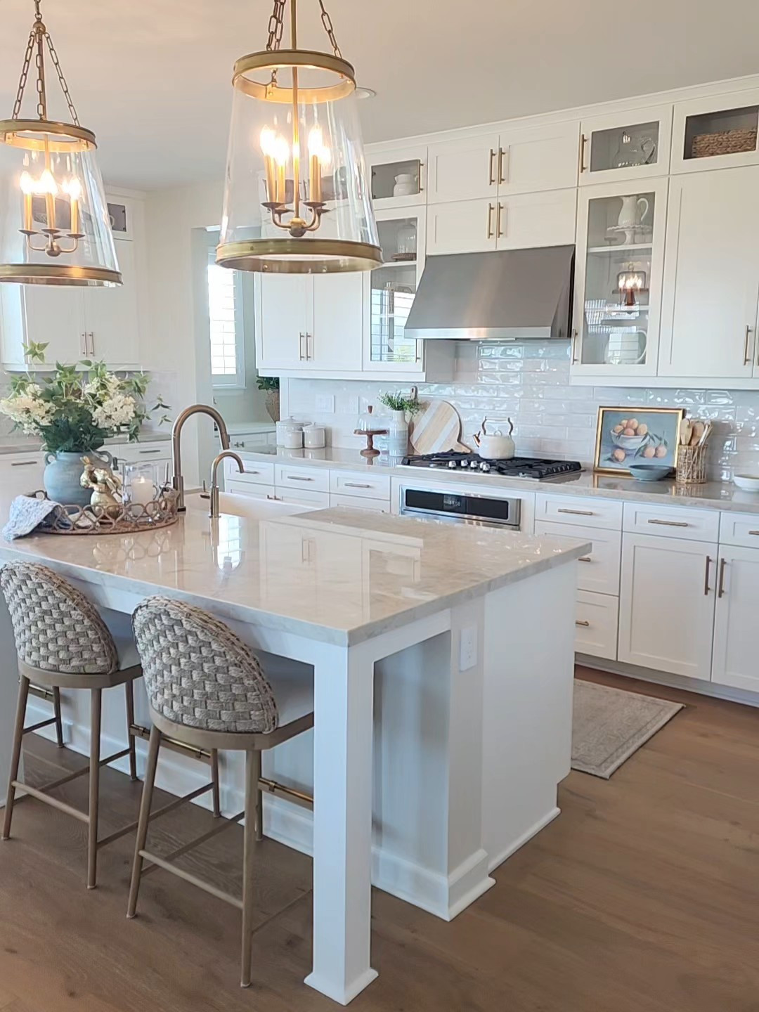 Coastal Timeless kitchen design. These beautiful statement pendant lights are a favorite and my Counter Stools add that gorgeous woven Coastal texture to the space! 

#LTKHome