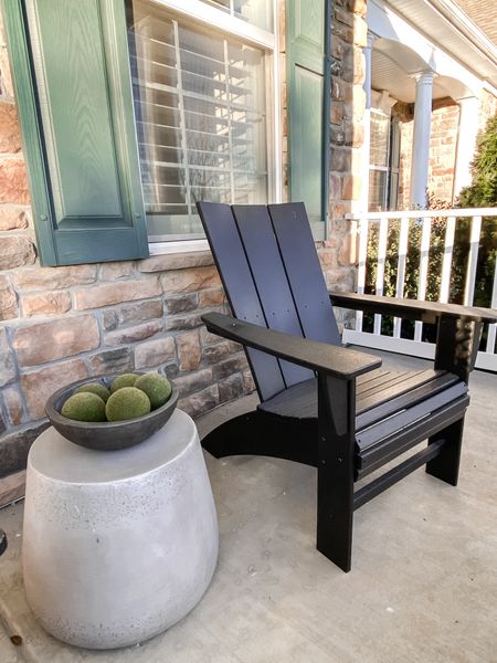 Front porch styling for spring:
Cement bowl with green moss filler.
Black Adirondack Chairs.
Cement side table.

#LTKhome