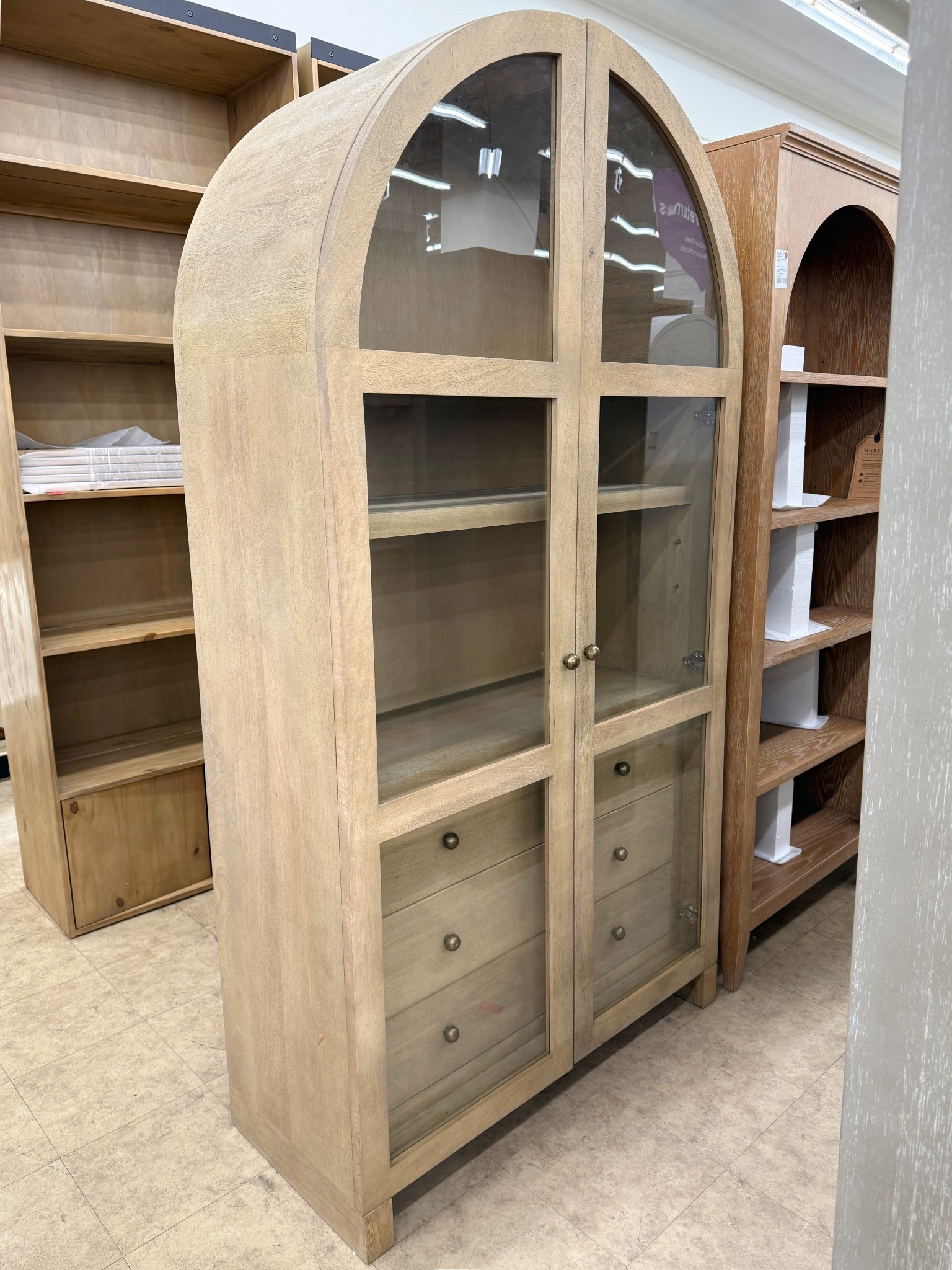 A true statement storage piece! 🤎 The Stonewall 80” Solid Wood Curio Cabinet from Joss & Main (available on Wayfair) brings so much character to a space. 😍 The arched glass doors, warm neutral wood tone, and brass hardware give it that elevated, collected look, while the adjustable shelves and drawers make it incredibly practical for everyday living. ✨Perfect for styling dishes, books, ceramics, or decor in a dining room, living space, or entryway. I’ve linked this cabinet along with other beautiful arched styles worth checking out! 💫 #FurnitureFind #HomeInspo #Wayfair

#LTKSaleAlert #LTKHome