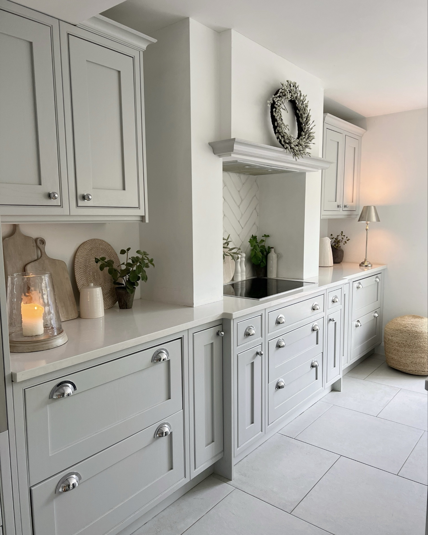 Kitchen 🤍✨

Painted in Dulux pure brilliant white, cabnets are DIY kitchens.

White company wreath, Dunelm jug, chopping boards, hurricane jar, herb pot, lamp, placemats