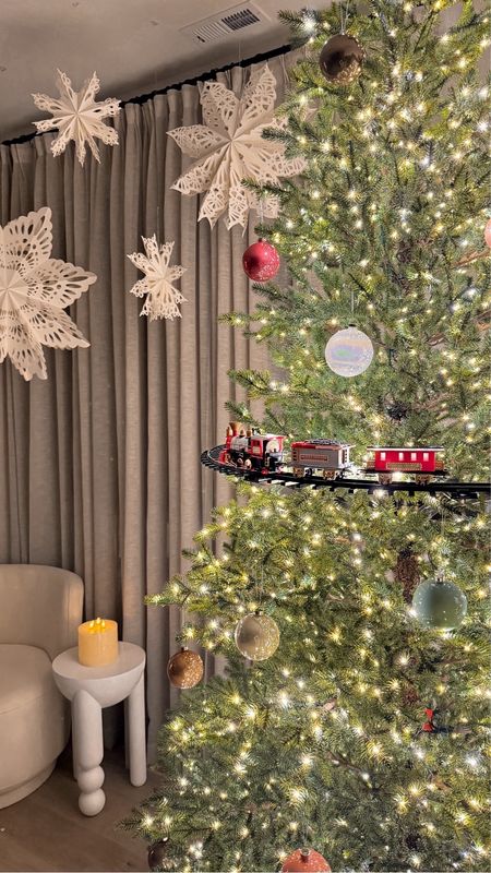 Christmas tree train set from Home Depot for $39

Glass ornaments and snowflake paper lantern from West Elm

Christmas decor trend 2023, Christmas tree train that wraps around the top of the tree Sale #LTKHoliday

#LTKhome #LTKHoliday