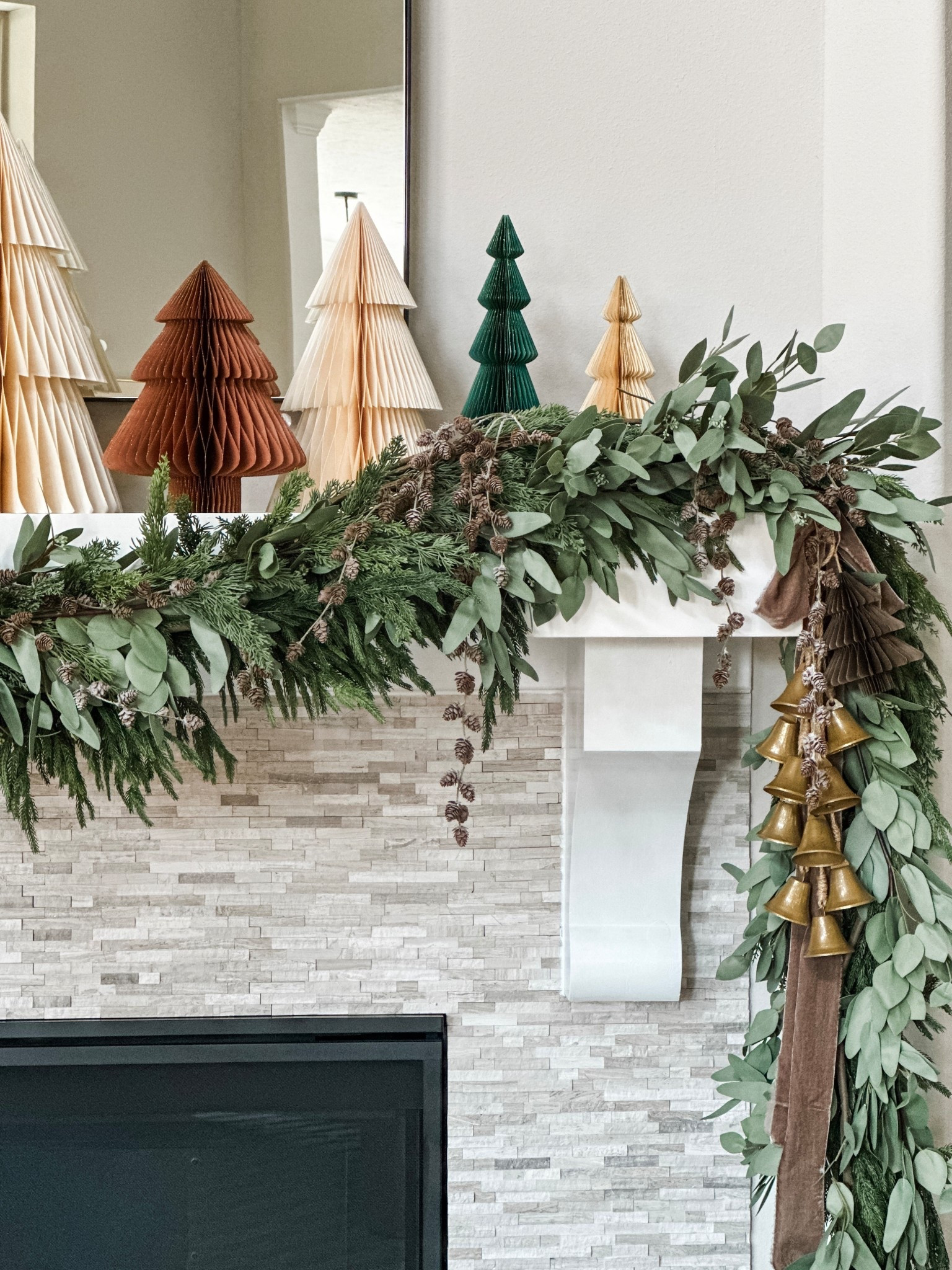 Neutral home holiday mantle decor! Holiday decor  neutral home  Christmas tree decor  mantle styling  garland  eucalyptus garland  Christmas bells  paper trees  neutral home decorr

#LTKSeasonal #LTKStyleTip #LTKHome