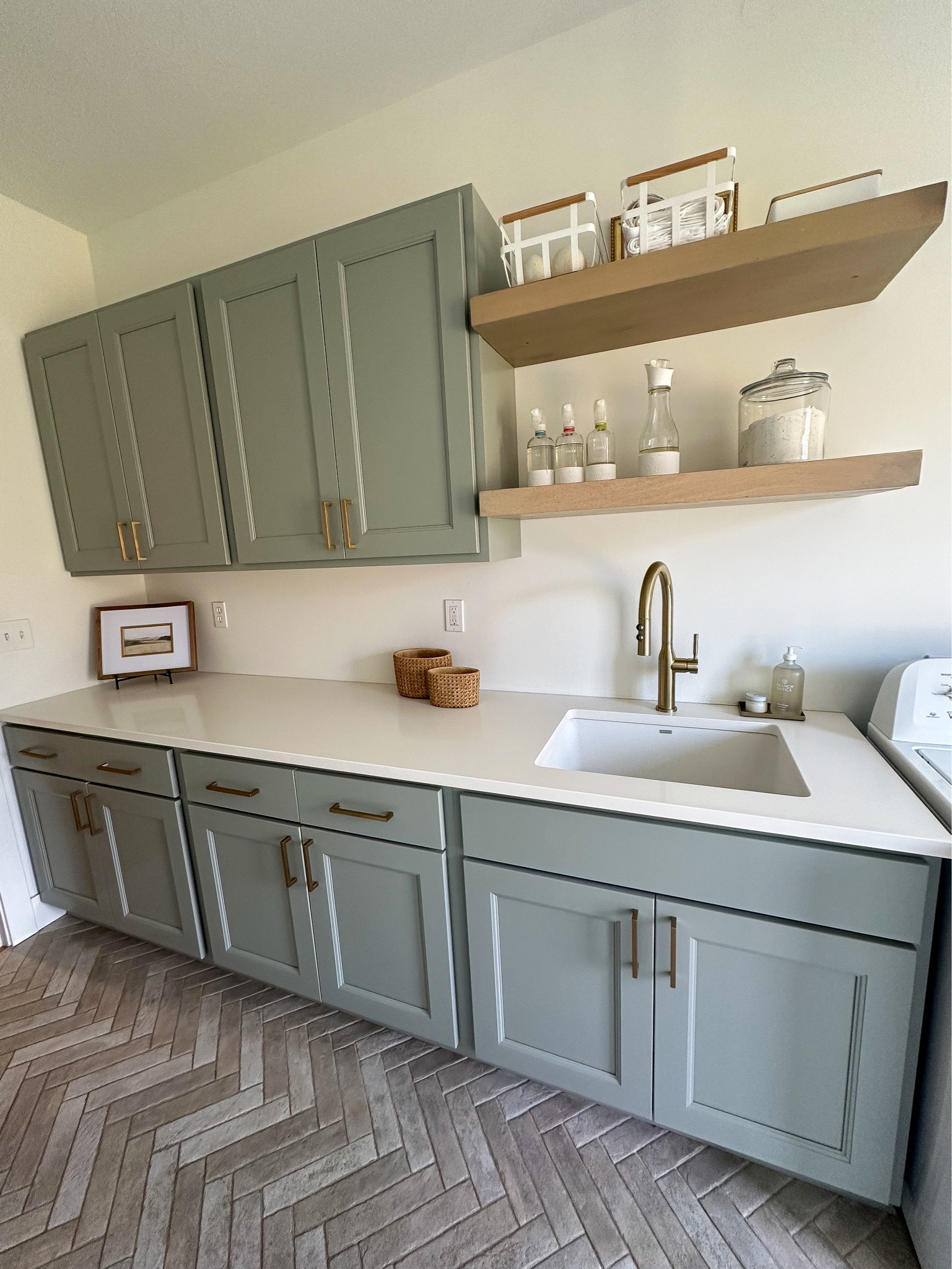 Laundry room, tile flooring , floating shelves, gold faucet, 

#LTKhome #LTKsalealert