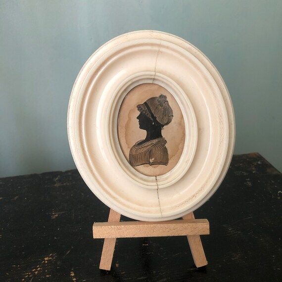 An antique Silhouette, young lady, oval frame | Etsy (US)