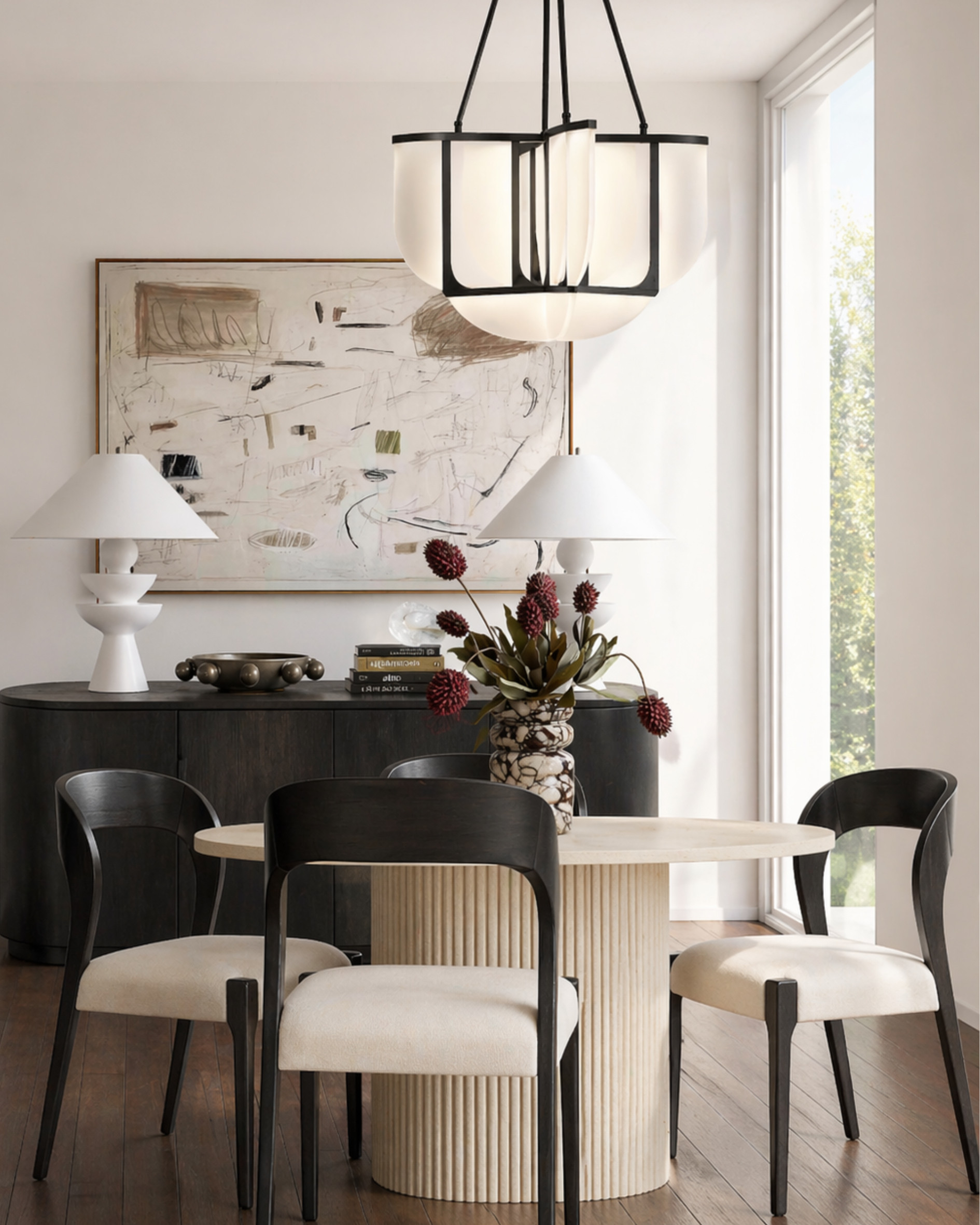 This is the kind of dining setup that makes everything feel intentional without trying too hard.

The mix of soft neutrals and black contrast keeps it grounded, while the sculptural base and curved chairs add just enough interest to make it feel elevated. It’s clean, but not cold—every piece actually pulls its weight.

If you’re designing a dining space, this is a solid formula: one statement table, balanced lighting, and a few high-impact accents instead of over-styling.

I may receive a commission if you purchase through my links. 

 #LTKHome