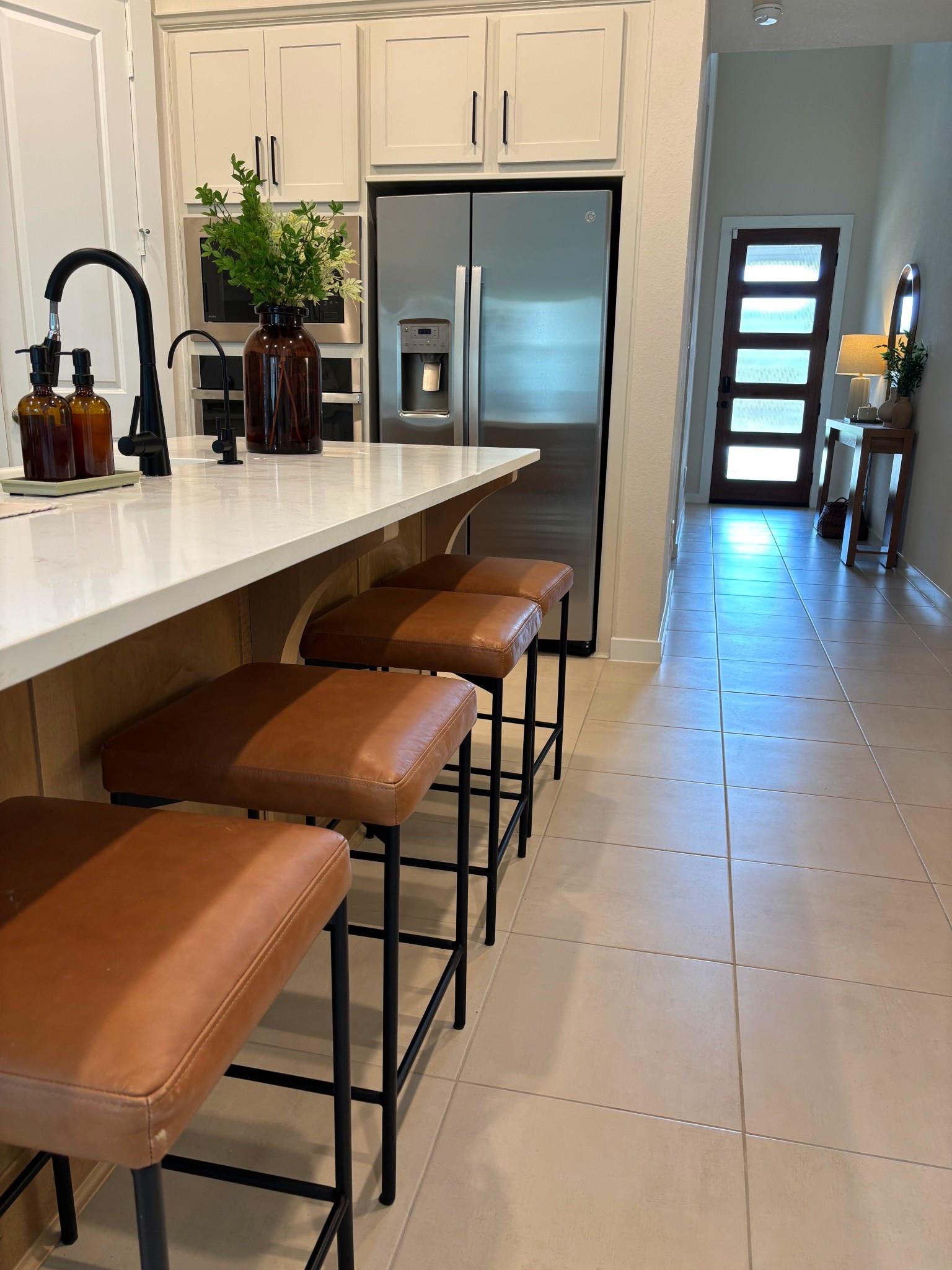 These barstools are the perfect addition to our kitchen! Loving the cushioned seat and traditional stool look which perfectly adds warmth to the room! Styled the island with a large target amber vase and greenery and switched out our soap dispensers to match the amber! Perfect contrast and warmth! 

#LTKHome #LTKSummerEdit #LTKFamily