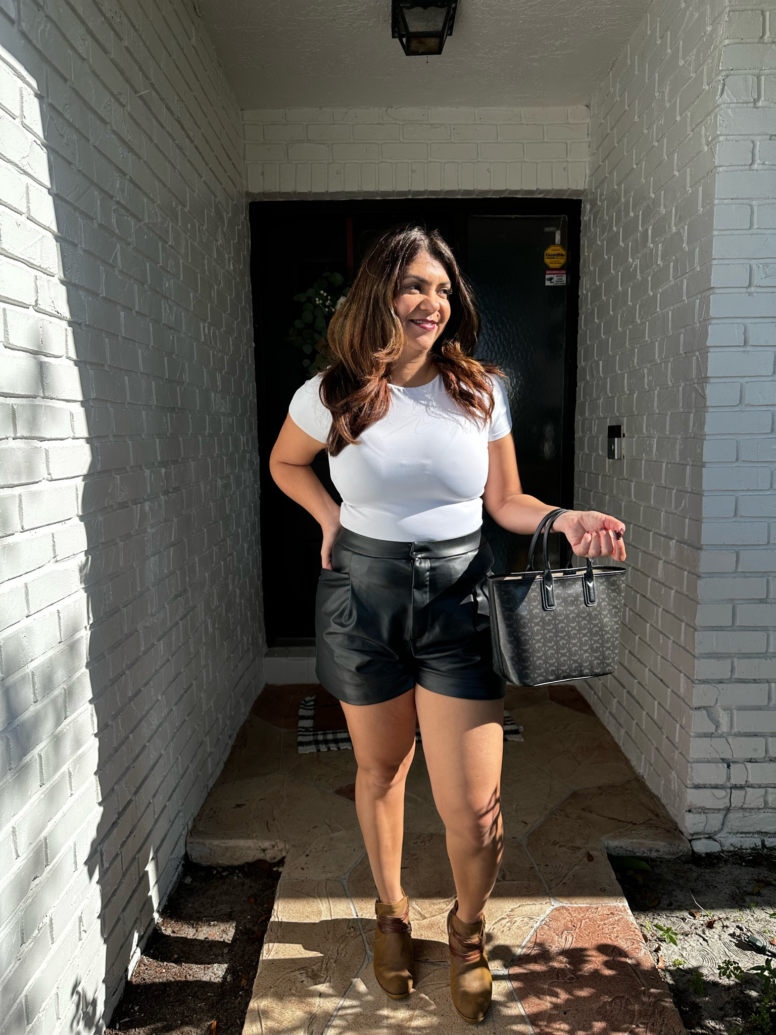 This is what I wore for our Christmas photos in Florida. Love how versatile the fake leather shorts are in black. Paired with white top from express and some boots for a touch of rustic and loving my new Michael Kors handbag in black. 

#LTKHoliday #LTKstyletip #LTKcurves