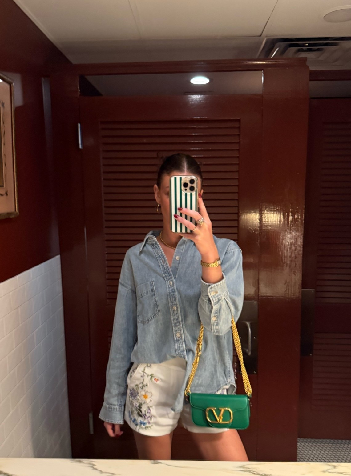Aritzia denim button down shirt with Alice and Olivia white shorts and green sandals.            summer outfit ideas, cute summer outfit, summer fashion 2026, summer outfit inspo, elevated casual outfit, chic summer outfit, European summer outfit, summer vacation outfit, summer brunch outfit, oversized button down outfit, denim button down outfit, denim shirt outfit, chambray shirt outfit, white shorts outfit, embroidered shorts, floral embroidered shorts, blue and white outfit, green accessories outfit, green handbag outfit, green sandals outfit, strappy sandals outfit, gold jewelry outfit, feminine summer outfit, coastal chic outfit, classy summer outfit, trendy summer outfit, summer fashion finds, shop my outfit

#LTKootd #LTKTravel #LTKTall