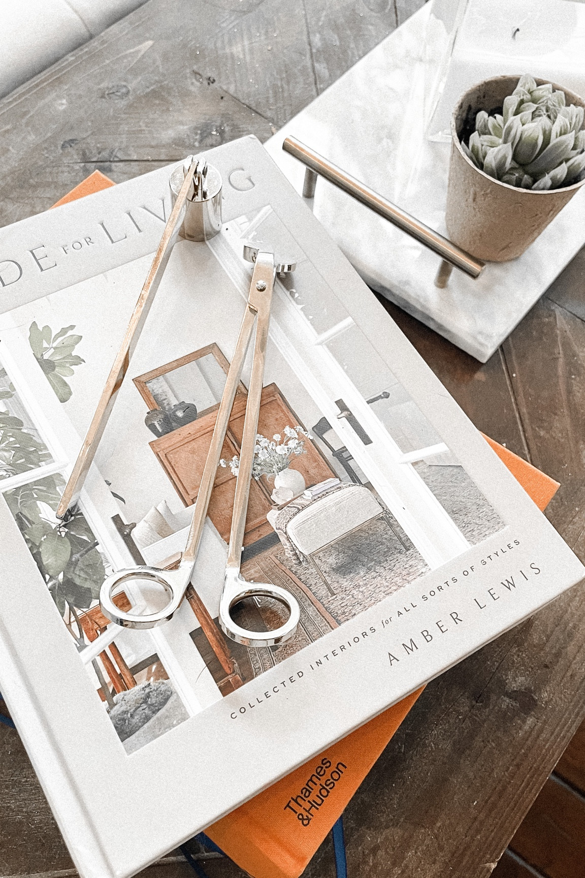 Shop this vignette photo 
Coffee table books 
Candle sniffer set 
Square glass candle holder 
Marble display tray 
Table lamp glass 