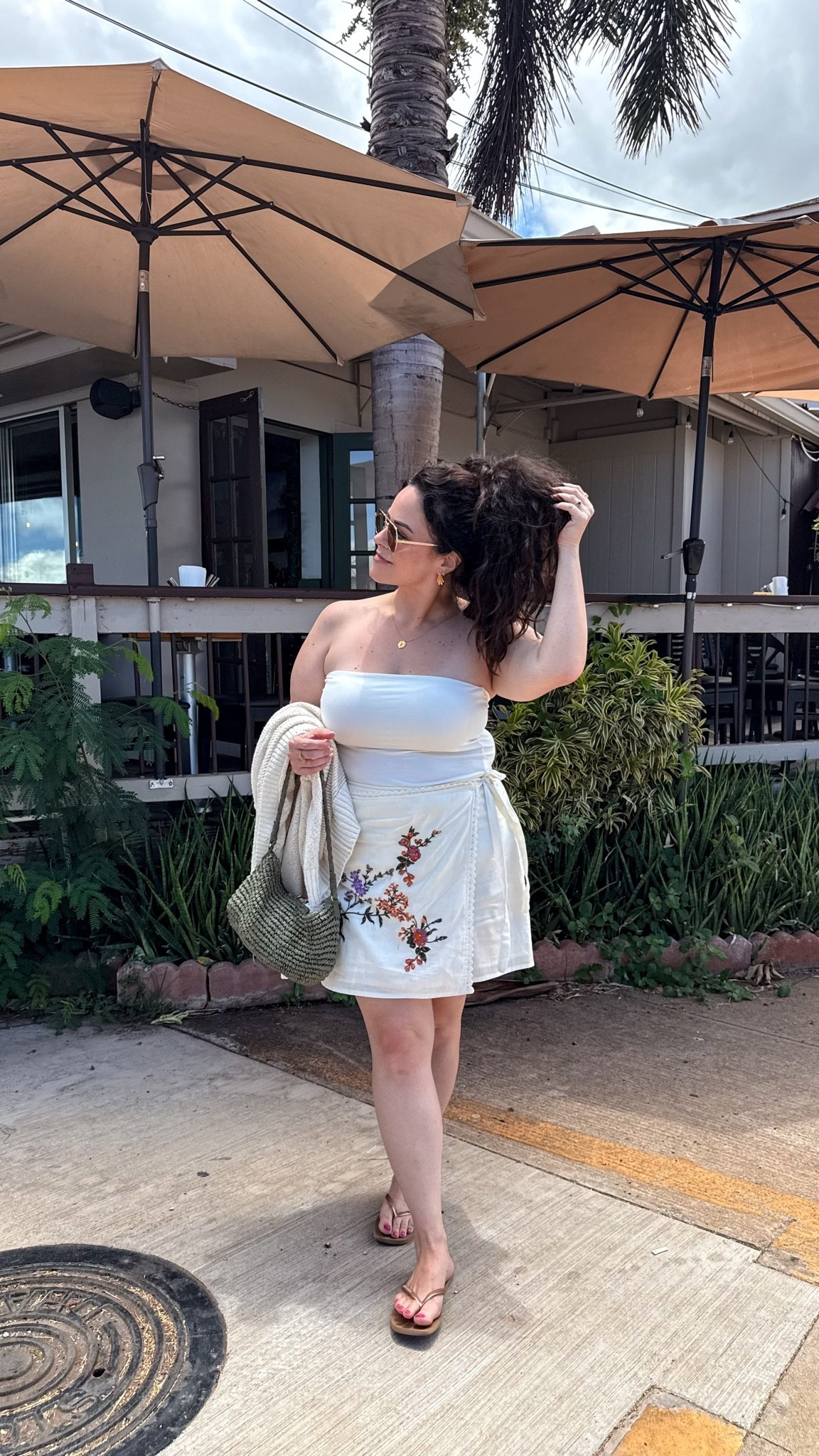 midsize vacation outfit, hawaii outfit. 

•wearing a xl in the tube top
•i am typically a 36dd in bras wearing a 38d in my fave strapless bra. 
•beach cardigan large 
•this embroidered wrap skirt is old i linked similar options. 
fave flip flops 
•green straw bag

#LTKOver40 #LTKTravel #LTKMidsize