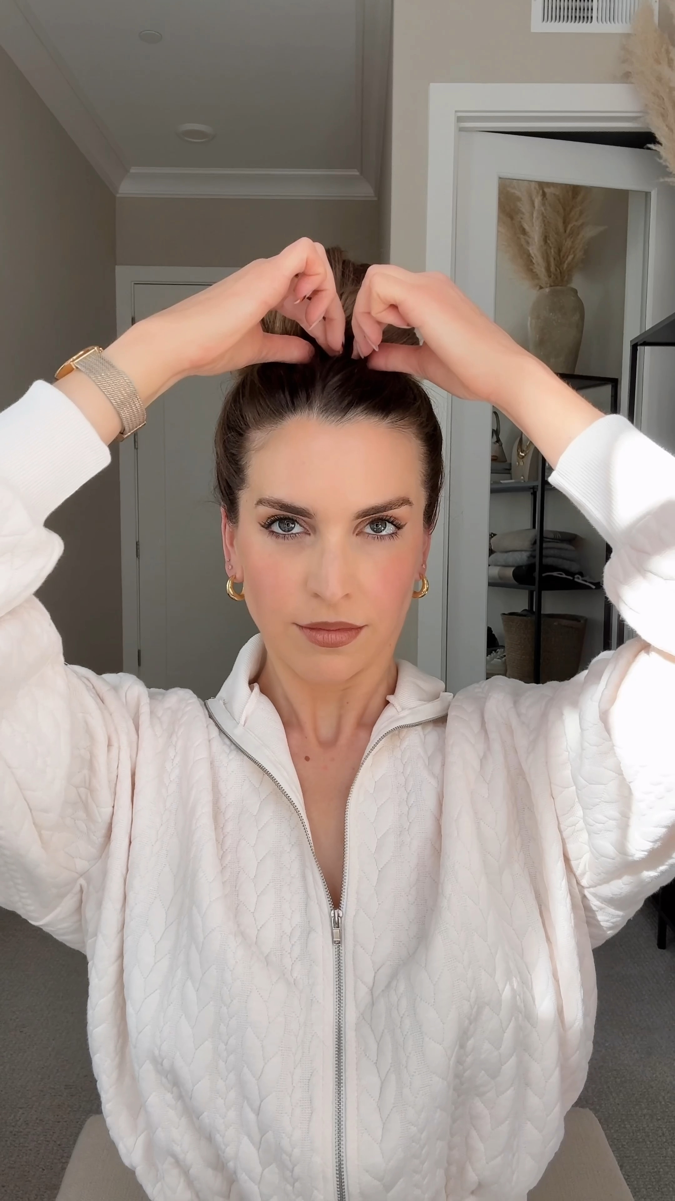 Twisted Topknot Hair Tutorial 💁‍♀️

Start by gathering your hair into a high ponytail. Create a mini loop by pulling the hair tie over the ponytail, but don’t pull all the hair through. Place your hand inside the elastic as you swoop the hand under the ponytail. Now, guide your hand clockwise, gathering the ponytail onto the elastic as you twist once. Once the twist is secure, pull the elastic, now wrapped with hair, back over the mini loop you formed earlier. Adjust and gently tug at the bun to shape.

#LTKSeasonal #LTKVideo #LTKBeauty