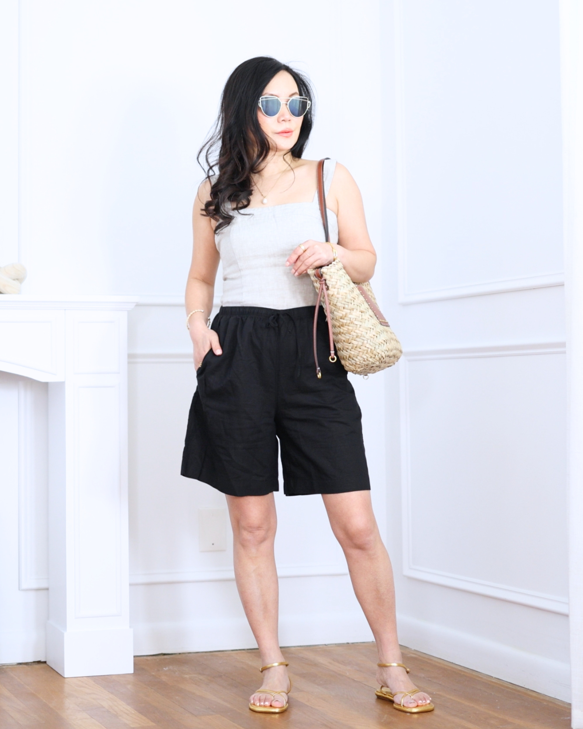 Linen black shorts from Uniqlo paired with a fitted linen tank from Quince and gold strappy sandals from BR Factory — simple, breezy, and effortlessly chic for warm days. I'm 5'2, wearing size S. 

 #LTKootd #LTKOver40 #LTKPetite