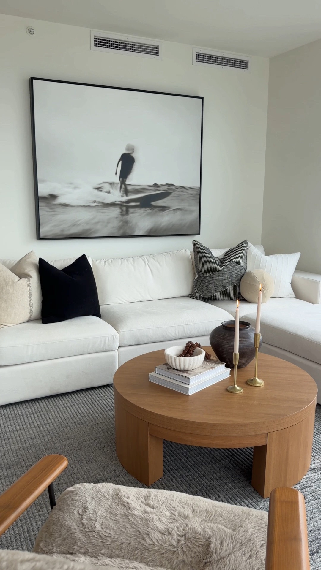Six steps. One living room. Let’s go!

I did this one backwards. I should have showed you when we moved into our temporary home how to furnish a space quickly so you can feel at home from day one. But it is never too late because empty rooms can be intimidating. And here is the secret, it isn’t about a bigger budget. It's about finding the right pieces both scale and style. Here's how I furnished my own living room, one click at a time.

Rug: The foundation. Go bigger than you think. Front legs of the sofa on it, minimum.

Art: Yes, before the sofa. Let it set the palette for everything that follows.

Sectional: The workhorse. Comfort first, then size it to your room, not the showroom.

Coffee table: About 18 inches from the sofa. Close enough for your wine, far enough for your knees.

Pillows: This is where the personality lives. Mix scale and texture, not just color.

Accessories: Edit, edit, edit. A few pieces that look beautiful beat a shelf full of filler.