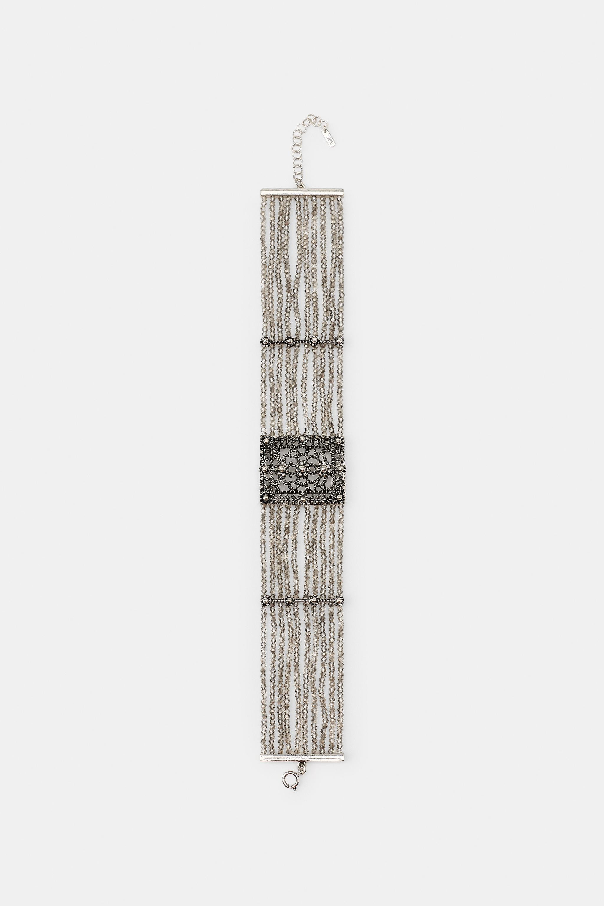 4 cm wide choker necklace with multiple beads. Featuring a rectangular metal centrepiece with emb... | Zara UK