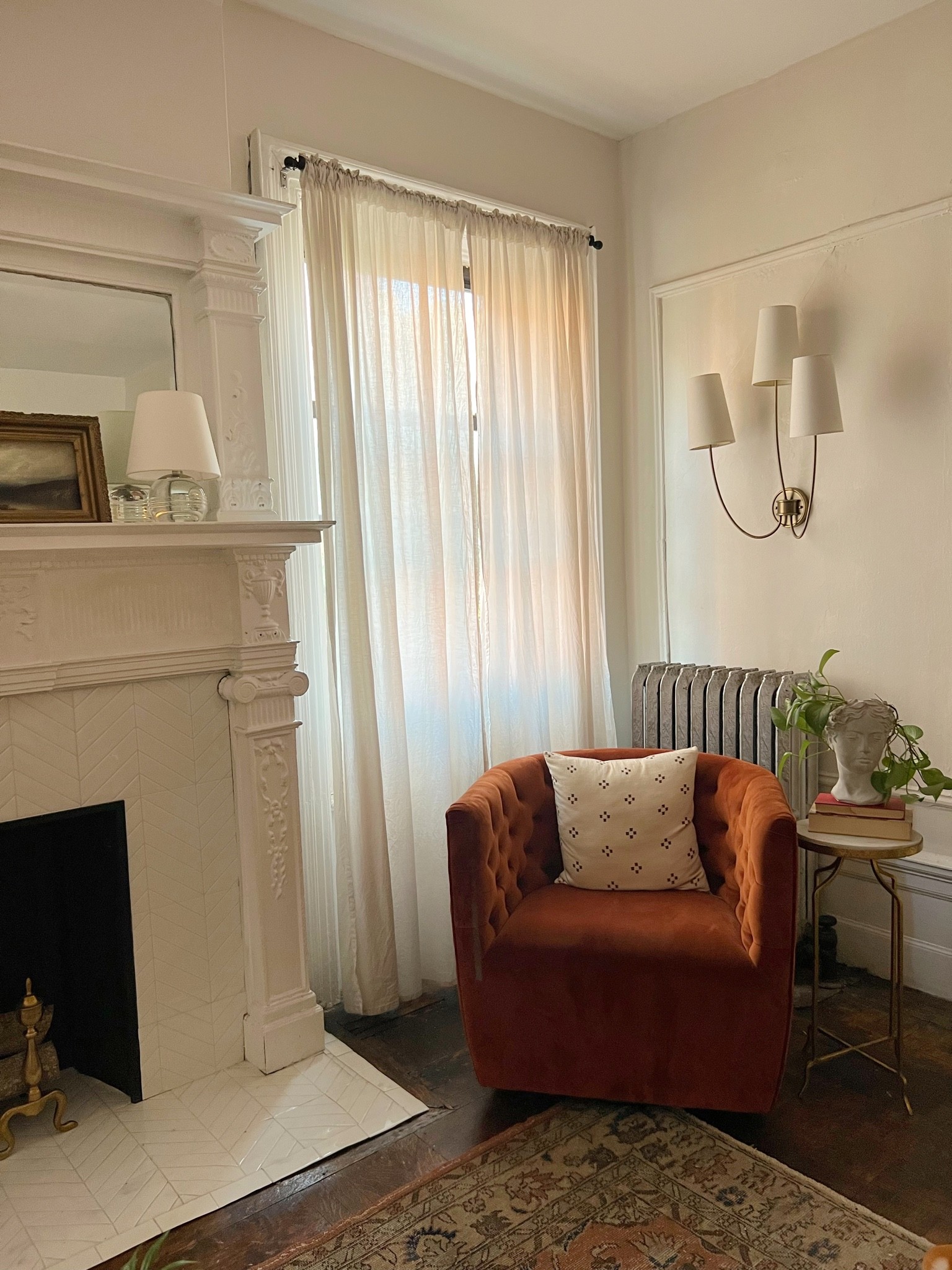 Rust velvet swivel chair, living room furniture, bust planter, good side table, wall sconces 

#LTKstyletip #LTKsalealert #LTKhome