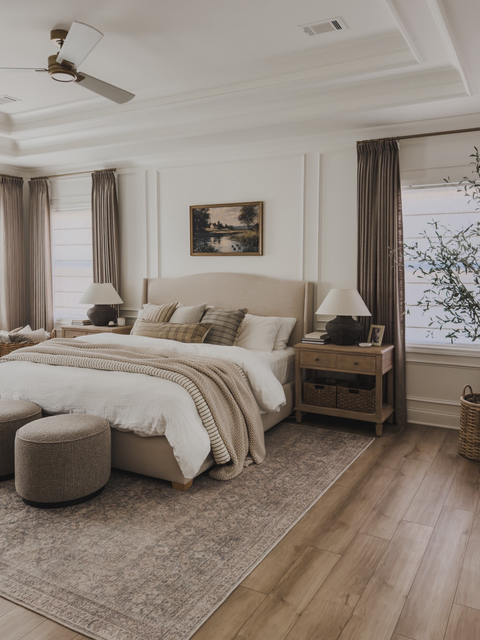 Timeless, collected primary bedroom! When refreshing this space post holiday season, I focused on soft, cozy layers blending with prints, texture, and just a pop of color for added depth. This creates a great palette for every day living that transitions seamlessly into spring.

Home finds, neutral home inspo, primary bedroom refresh, collected style, quality over quantity, linen upholstered bed frame, arch wingback bed, linen pinch pleat curtain, moody curtain, brass details, cozy bedding, layered bedding, throw blanket, striped quilt, moody lamp, neutral wood tones, nightstand details, vintage style area, ottoman favorites, digital art, roman shades, faux olive tree, ceiling fan, wicker basket, cozy throw pillow, Loloi, Amber Lewis, Pottery Style, Target style, Two Pages, Visual Comfort, Galey Alix, Livabliss, Etsy, shop the look!

#LTKSeasonal #LTKHome