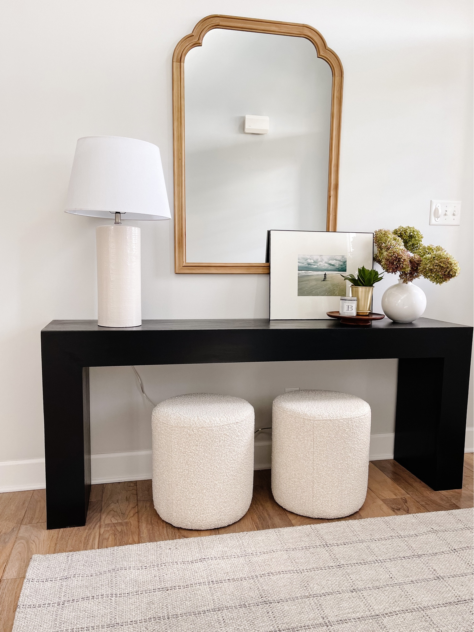 Entryway decor idea.  This black console table is a DIY project. Head over to afinishedhouse.com for a completed step-by-step guide. 
I linked similar ones, and all the elements of this entryway. 
Modern entryway decor, Target finds, console table, entryway styling. Black entryway table, wood frame mirror, plaid rug 

#LTKhome #LTKFind #LTKstyletip