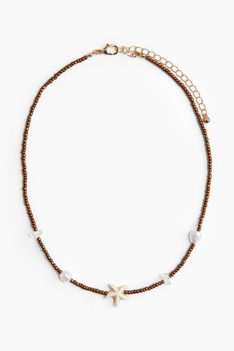Short beaded necklace - Dark brown/Starfish - Ladies | H&M GB | H&M (UK, MY, IN, SG, PH, TW, HK)