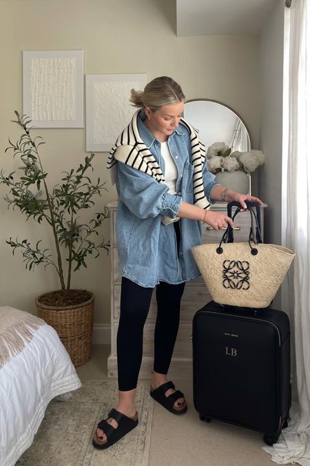 Spring summer travel outfit - Katie Loxton black suitcase, Loewe basket bag, Uniqlo bra vest top, H&M denim shirt, arket striped jumper, sweaty Betty black leggings & black Birkenstock Arizona sandals

#LTKeurope #LTKtravel #LTKstyletip