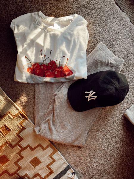 Summer outfit on repeat: cherry t-shirt • black hat • flared knitted pants • black hat • Yankees hat • summer tee • cherries 

#LTKStyleTip