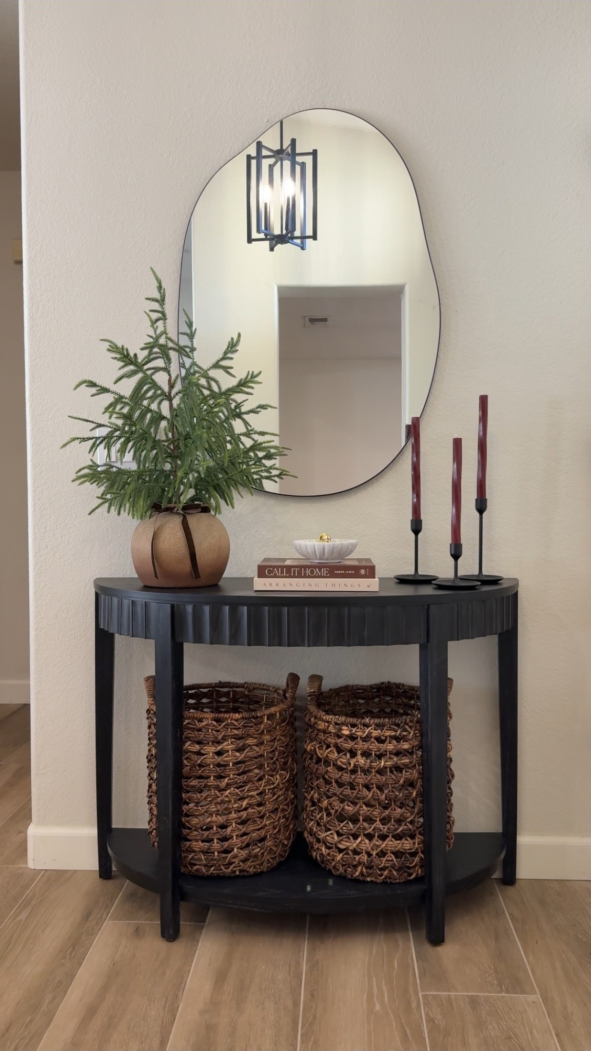Entryway table styling for Christmas! 🎄 Easing into the holiday decor with these subtle Christmas touches. 

This Norfolk tree and pot are from Hobby Lobby, linked some similars. 

These twisted red taper candles have a shimmer to them, making them ever more beautiful! And the addition of gold bells add the perfect festive touch✨

•
•
Christmas decor, Christmas decorating inspo, Christmas decor ideas, Christmas tree, Norfolk pine tree, neutral Christmas, classic Christmas, nostalgia Christmas, Ralph Lauren christmas, decor ideas, cozy home, decorating ideas, foyer decor, entry table, console table styling 

#LTKHome #LTKHoliday #LTKSeasonal

#LTKSeasonal #LTKHoliday #LTKHome