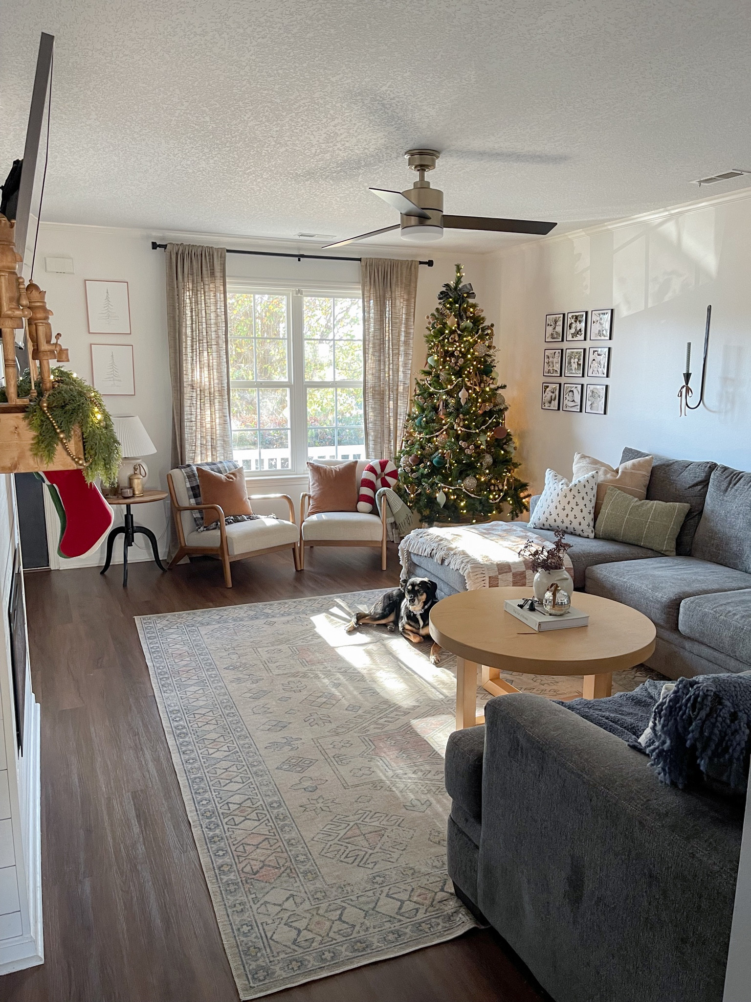 Christmas living room decor. Holiday decor. Living room design. Sectional couch. Round coffee table. Christmas tree. Accent chairs. Christmas neutral pillows. Candy cane pillow. Throw blankets. Candle sconce. 

#LTKHoliday #LTKSeasonal #LTKhome