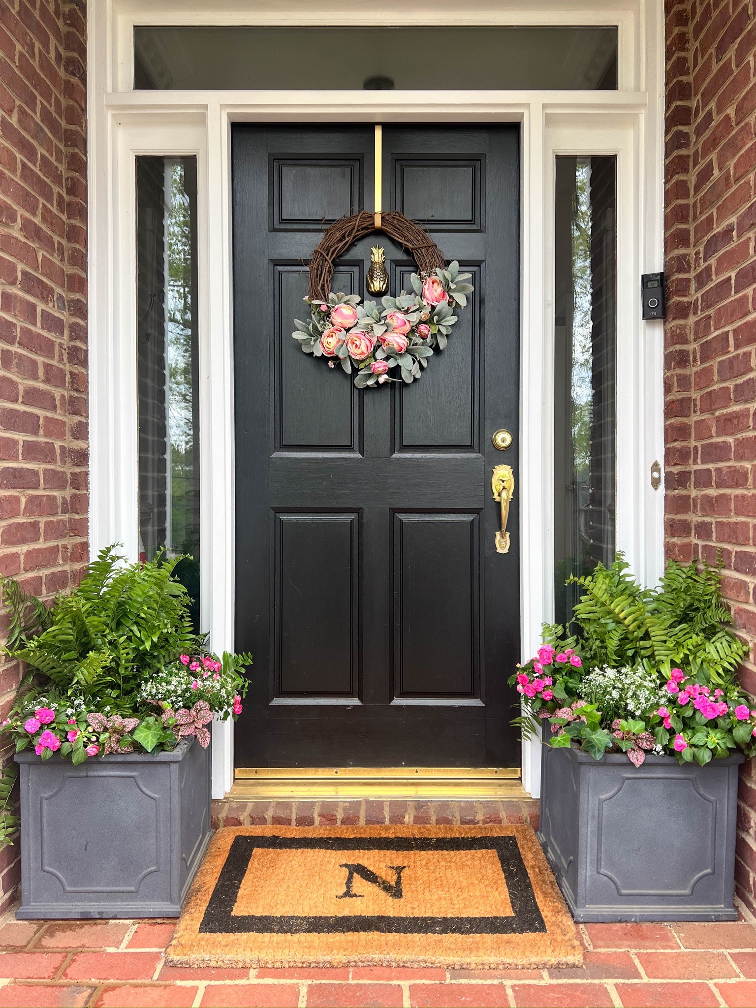 My springtime front door features pinks and greens in these great gray planters. 

#LTKHome #LTKSeasonal