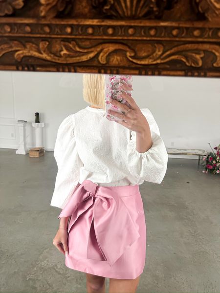 Pink bow mini skirt with the cutest white puff sleeve blouse! Perfect date night or GNO look! 

#LTKfindsunder100 #LTKstyletip