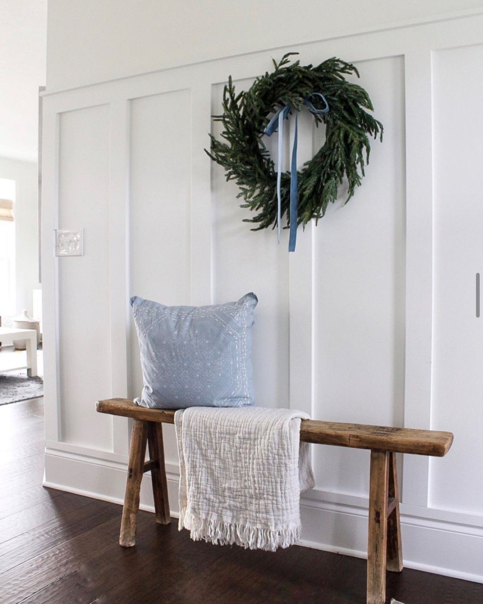 Entry way holiday decor. Simple blue and green Christmas decor, wreath. Norfolk pine wreath with pale blue velvet ribbon  

#LTKhome #LTKSeasonal #LTKHoliday