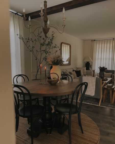 Round jute rug, round dining table, black chairs, chandelier, triple pleat curtains 

#LTKhome