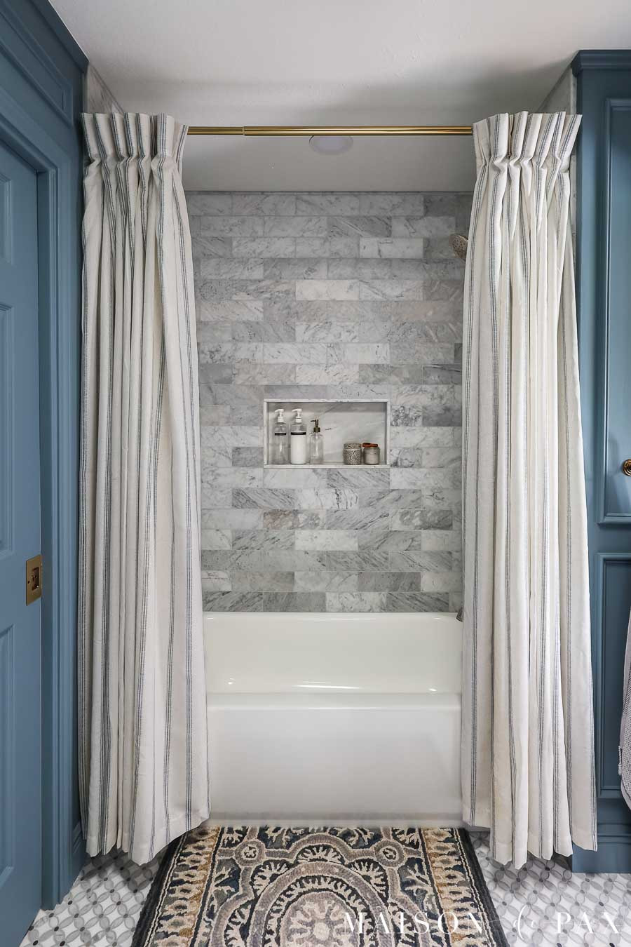 Instead of a standard shower curtain, I used curtain panels for a more tailored, elevated look. 
Paired with a brass rod and bold bath rug, it adds just enough drama without being fussy. 

 #LTKHome