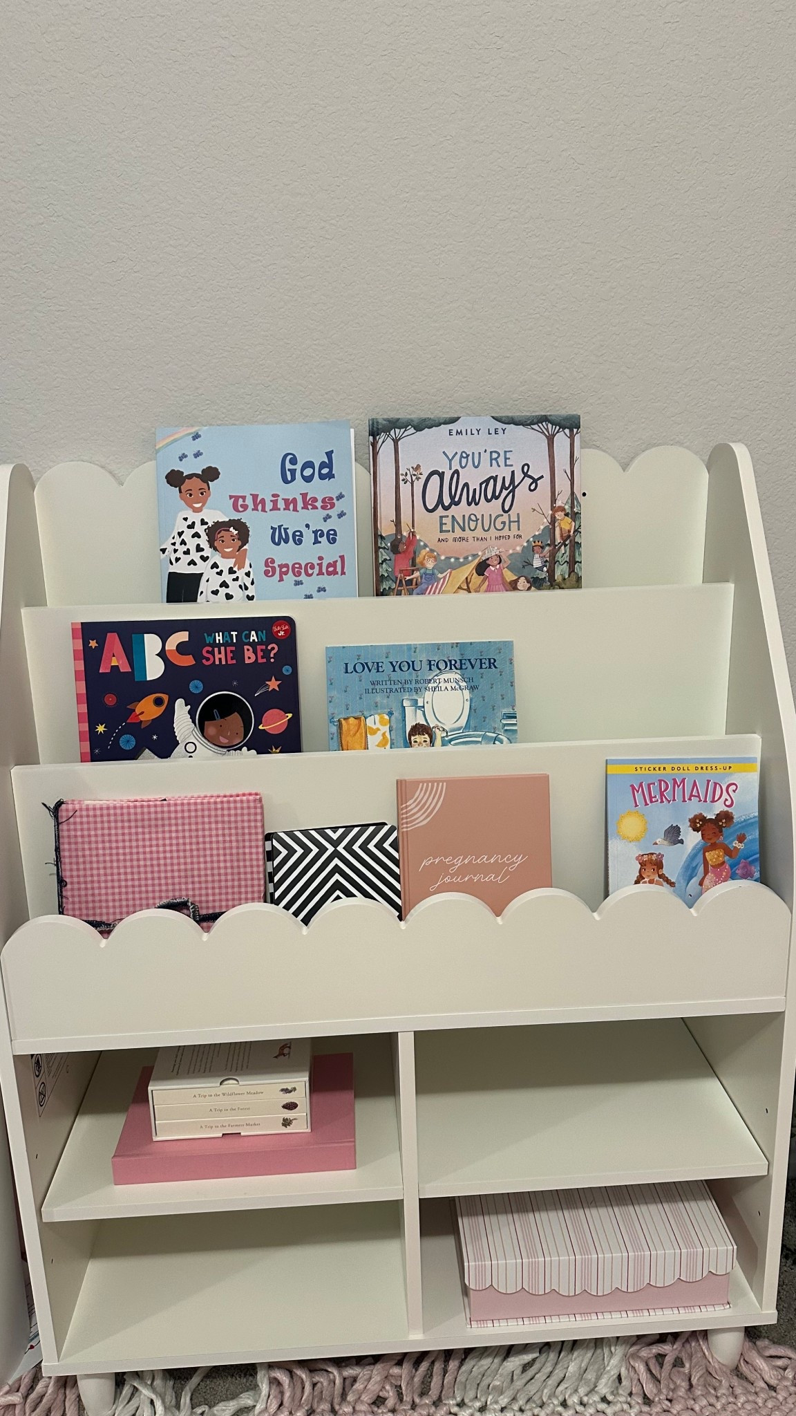 Obsessed with how this scalloped nursery bookshelf turned out! It’s the perfect way to display baby girl’s books, keepsakes, and a few sweet storage boxes. Found the shelf + most of the books on Amazon, all super affordable! Linking everything I used to style this cozy corner. #nurseryorganization #nurseryinspo #babybookshelf #amazonhome #LTKbaby #nurserystorage #babygirlnursery #LTKnursery

#LTKKids #LTKBump