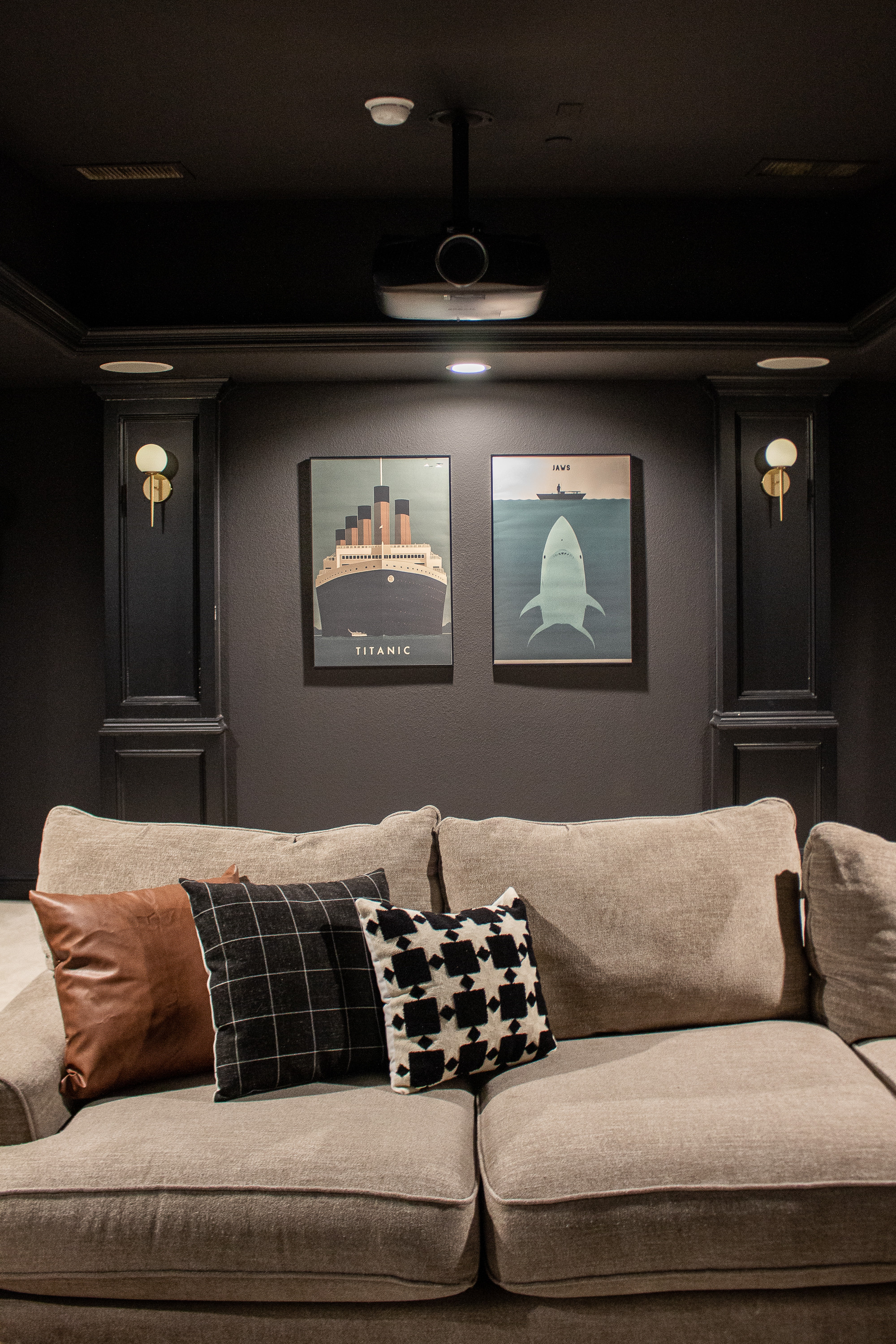 This home theater setup feels cozy, modern, and so intentional. The dark walls create the perfect movie-night atmosphere, and the framed Titanic and Jaws prints add a fun, cinematic touch. I love how the oversized sectional, textured pillows, and minimal decor keep the room comfortable without distracting from the screen.
Linking the wall art, sectional, pillows, lighting, and similar home theater decor pieces to help you recreate this warm, moody space.

#LTKHome #LTKSeasonal #LTKKids