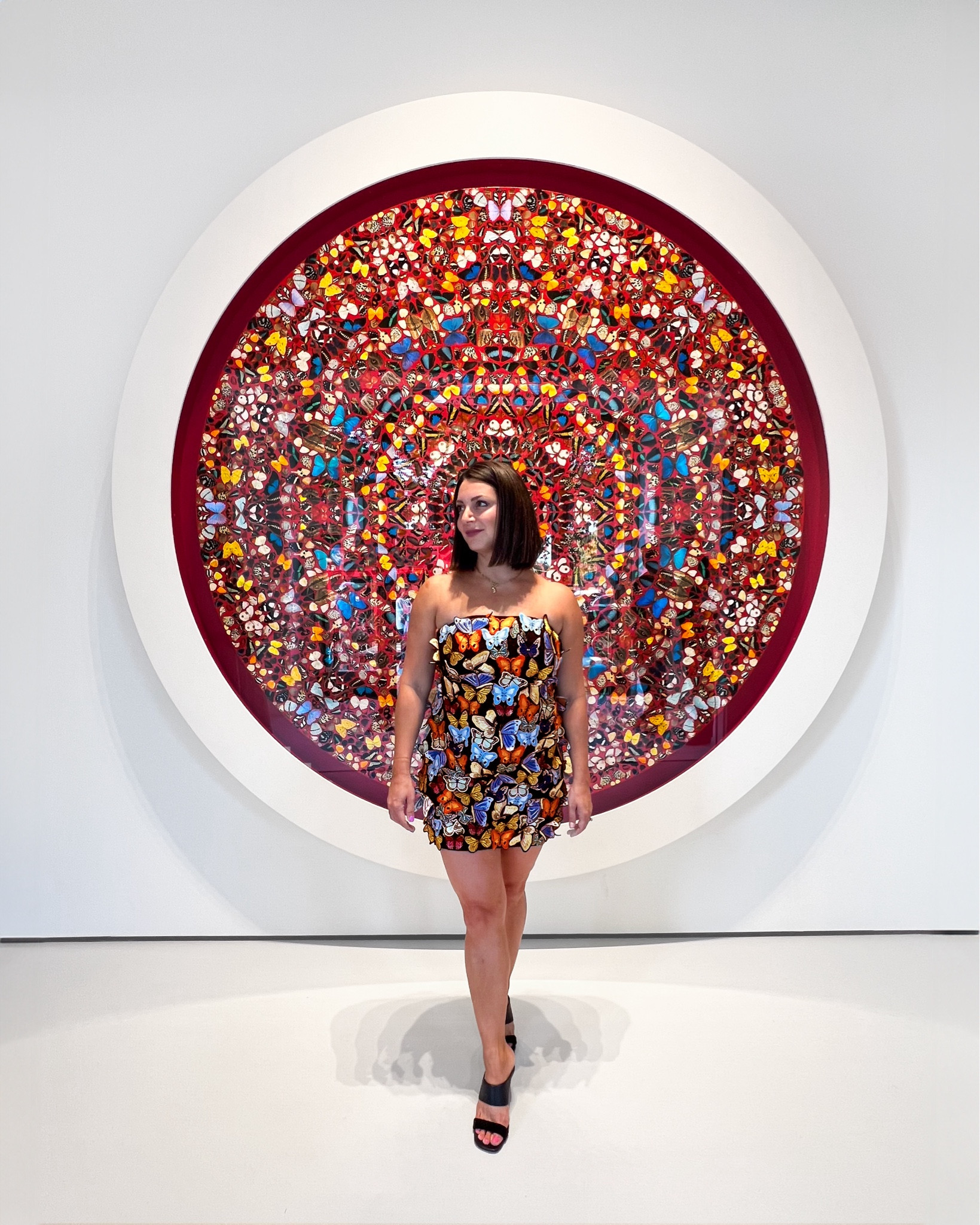 Christie Dressed To Match Damien Hirst At Moco London wearing 3D butterfly dress
