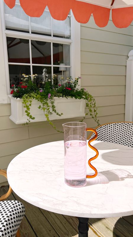 Love this wavy glass pitcher! Such a fun fancy splurge! Also linked our backyard table chairs, window flower box, and umbrella! 

#LTKSeasonal #LTKFind #LTKhome