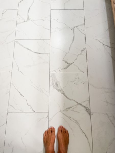 My favorite budget friendly master bath flooring for under $2 per square feet.  

12 X 24 porcelain tile.  Marble look alike flooring.  White porcelain tile.  

#LTKhome