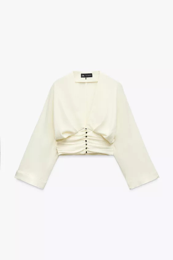 V-neck top with pleats and long sleeves, wide armholes, narrowing towards the wrist. Gathered hem... | Zara UK