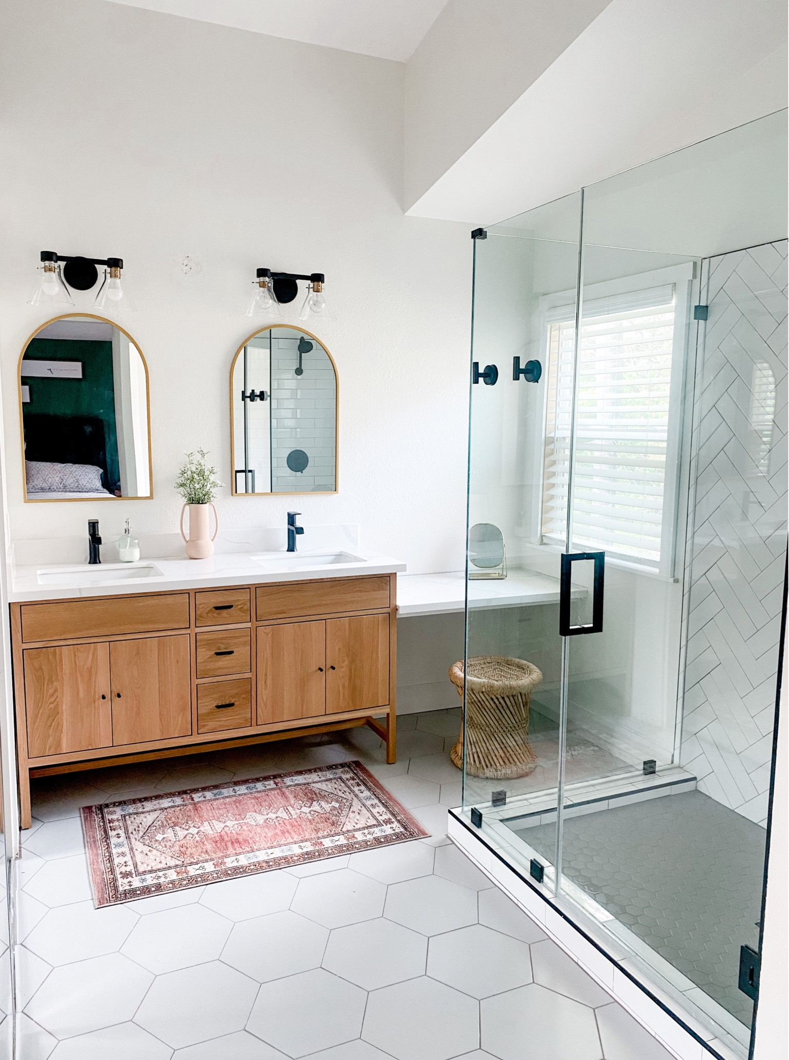 Master bathroom remodel, oak vanity cabinets, arched brass mirrors and matte black hardware, bathroom rug, bathroom lights, black bathroom faucets, gold arch mirrors #LTKunder100 #LTKFind

#LTKhome