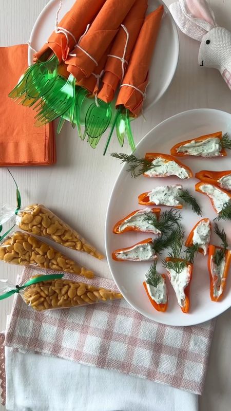 3 Carrot Themed Easter Ideas:
Here are some last minute easy Easter Ideas for creating memories and traditions with your family! 

1) Orange napkins wrapped around green cutlery to create the look of carrots when entertaining. You can secure with cooking twine and display in an empty terracotta pot for a festive touch, or on my favorite bunny cake stand!

2) Carrot shaped treat bags: fill cone shaped bags with cheese balls or goldfish crackers; secure with a twist tie and tie a green ribbon around the top. The treat looks orange like a carrot and makes a fun snack or party favor!

3) Mini pepper 'carrots': I buy bags of mini peppers and use the orange ones for this appetizer or snack. Slice peppers in half lengthwise and fill each pepper half with cream cheese or  ranch dip. (I use the ranch packets and substitute plain yogurt for the sour cream.) Finally, place a sprig of dill at the wider end to make the mini pepper look like a carrot. These are a cute and tasty appetizer or snack!

Save this post for later and follow along for more Seasonal and Holiday Ideas!



Easter , easter ideas , appetizers , easy snack idea , easter appetizer , bunny cake stand , amazon finds , amazon home #ltkhome

#LTKunder50 

#LTKVideo #LTKSeasonal #LTKparties