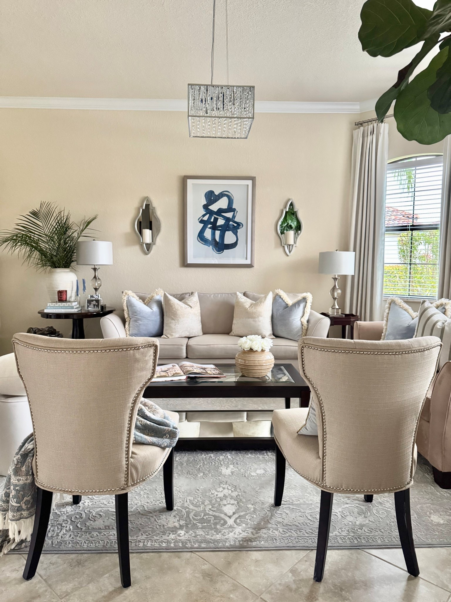 Our cozy living room view with a beautiful blend of warm neutrals, classic blues, rich wood tones, chrome & silver  fixtures, and fresh greenery!🩵💙🤎🩶🍃

Home Decor | Living Room Decor | Warm Neutral Decor | Classic Blues | Transitional Decor | Transitional Modern Coastal | Traditional Decor | Brown & Blue Decor | Classic Decor | Timeless Decor | Spring Decor

#LTKHome