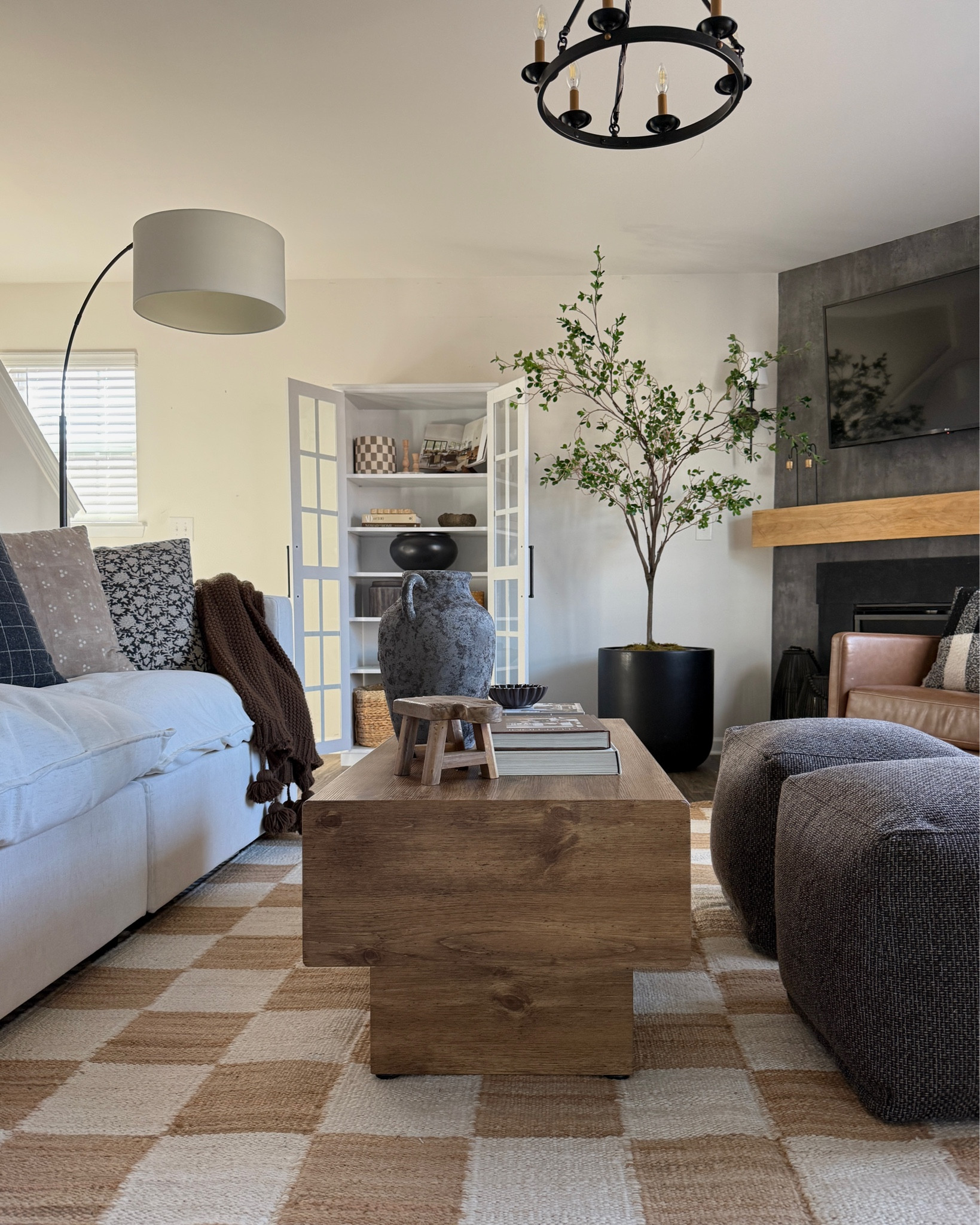Living room refresh!
Checkered jute rug, living room rugs, layered rugs, washable sofa, washable sectional, brown ottoman, leather swivel chair, white bookshelf, pb inspired decor

#LTKFamily #LTKHome #LTKSaleAlert