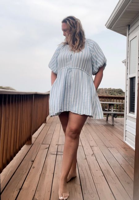 Styling a cabana style coverup sundress perfect for beach and pool days. It has pockets and functional buttons. Puff sleeves and a cinched waist string for flattering features. Wear this over a bathing suit or lounge around the house on hot days. 

#LTKcurves #LTKswim #LTKtravel