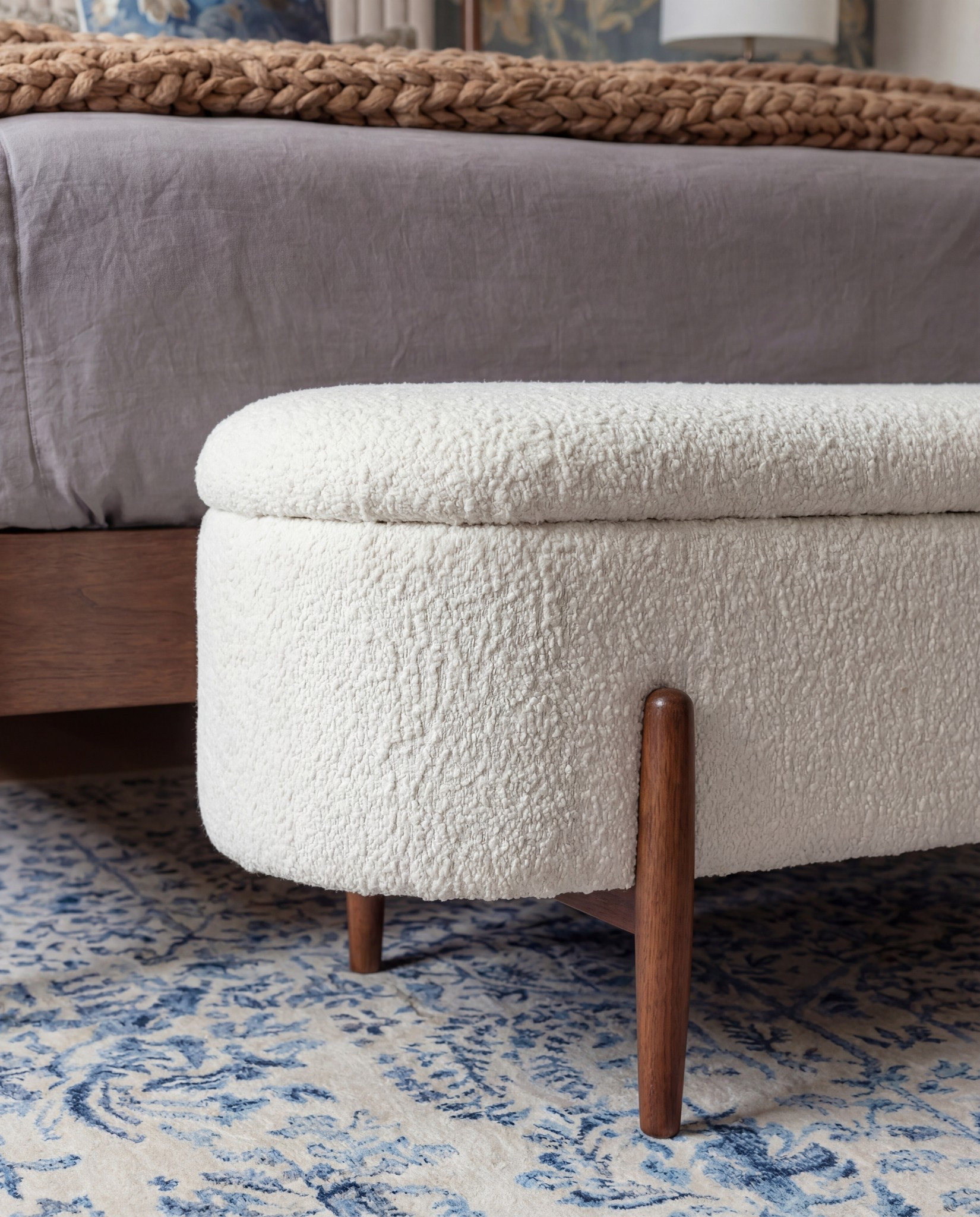 Shop The Look:
• Warm-wood platform bed frame
• Vertical-channel upholstered headboard
• Gray duvet cover + layered sheet set
• Mixed blue + neutral accent pillows
• Oversized chunky knit throw blanket
• Shearling-style upholstered storage bench at the foot of the bed
• Pair of dark-wood campaign-style nightstands with brass hardware
• White drum-shade table lamps with blue glass bases
• Blue decorative bowls
• Bead garland décor
• Stack of books (nightstand styling)
• Framed oversized floral artwork above the bed
• Blue floral wallpaper (full wall + ceiling)
• Exposed wood ceiling beams
• Blue patterned area rug
• Window bench with plaid/tan accent pillows

#LTKFindsUnder100 #LTKSaleAlert #LTKHome