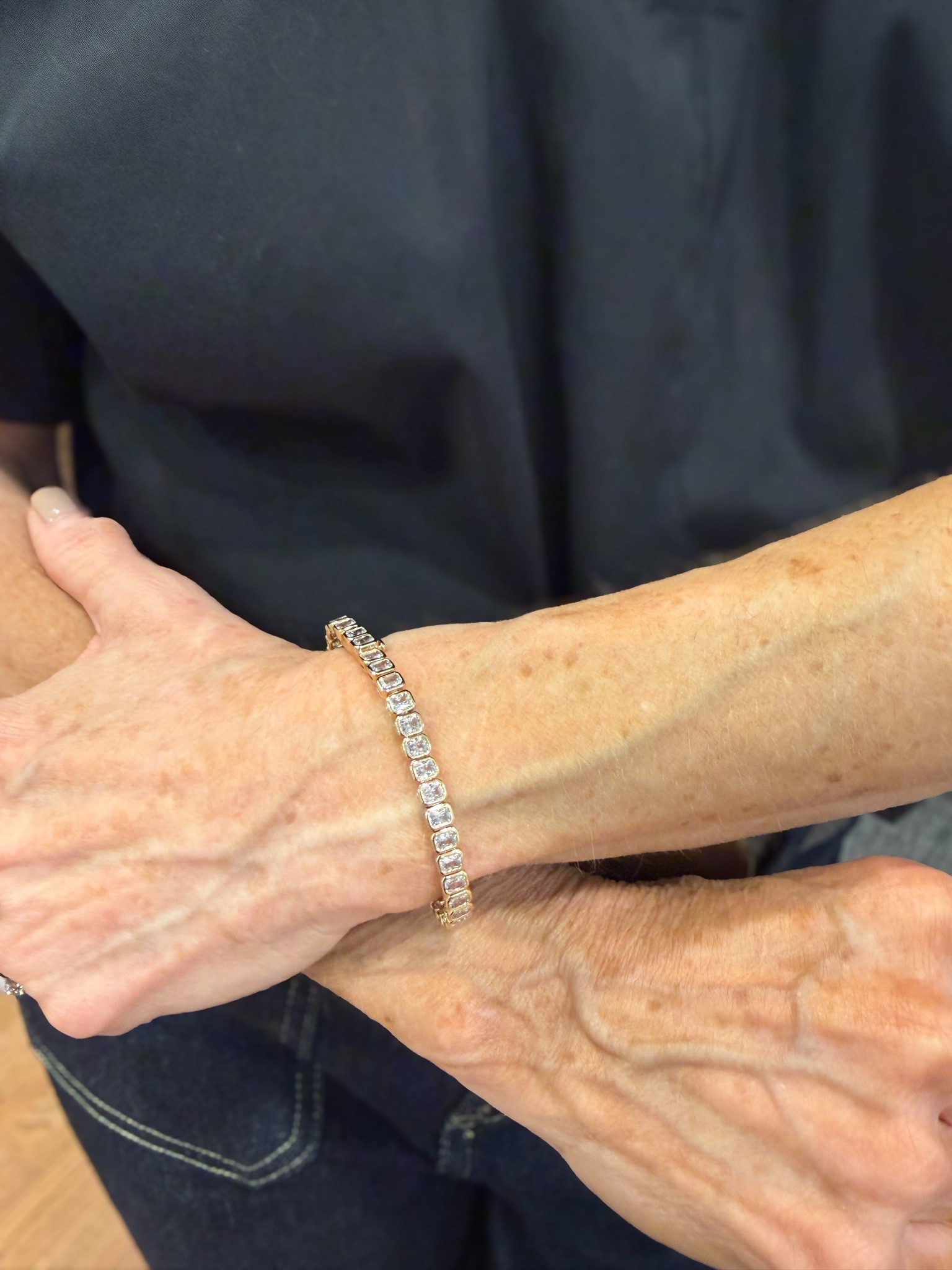 I love this emerald-cut bezel tennis bracelet, it's such a unique combination, an emerald cut stone in a bezel setting, so it really stands out while still being a classic tennis bracelet.  😍

It's high-quality cz, no one would know it's not real, and it's great for traveling since you're not worried about losing it.

#LTKSeasonal #LTKOver40 #LTKTravel