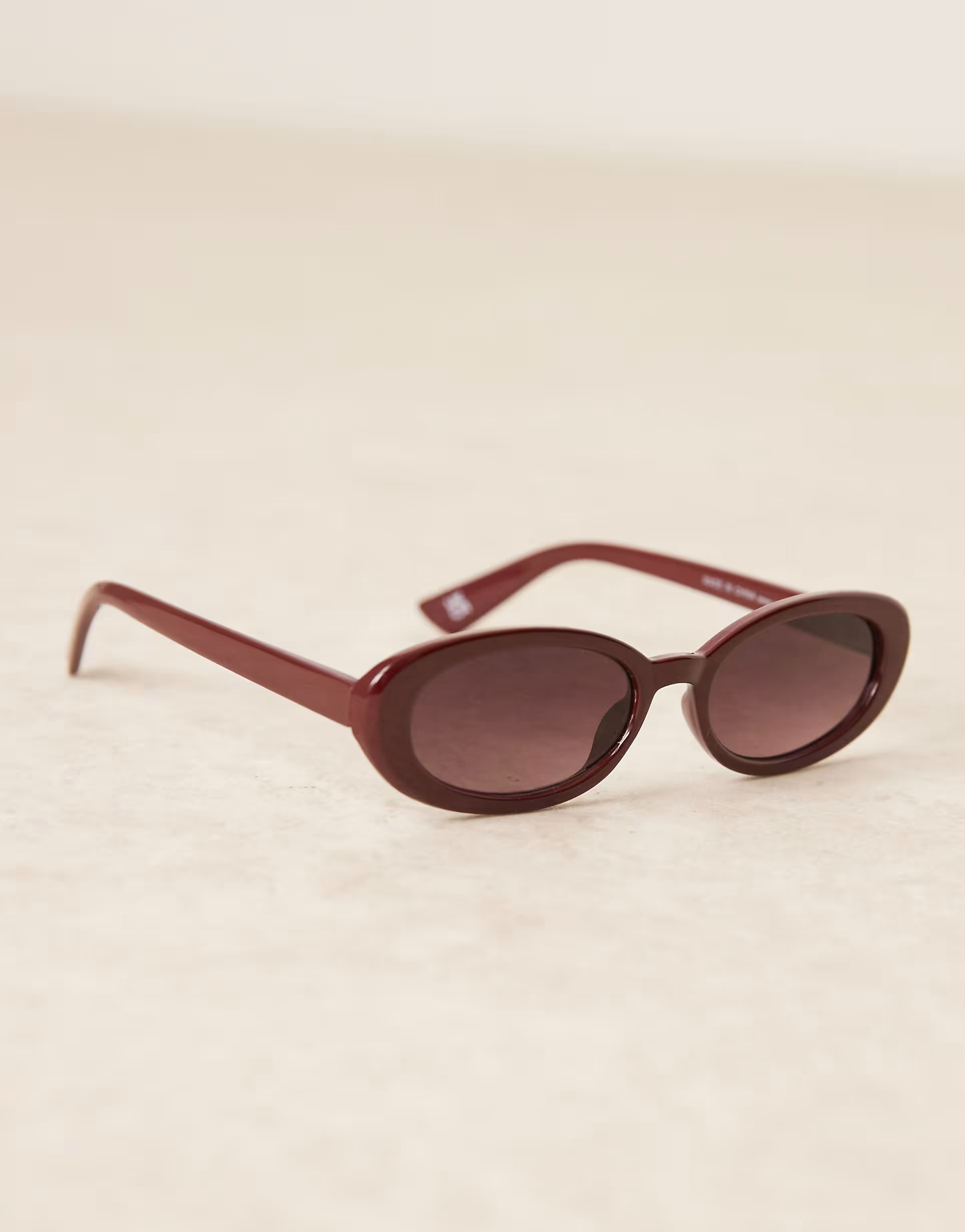 ASOS DESIGN skinny oval sunglasses in burgundy | ASOS | ASOS (Global)