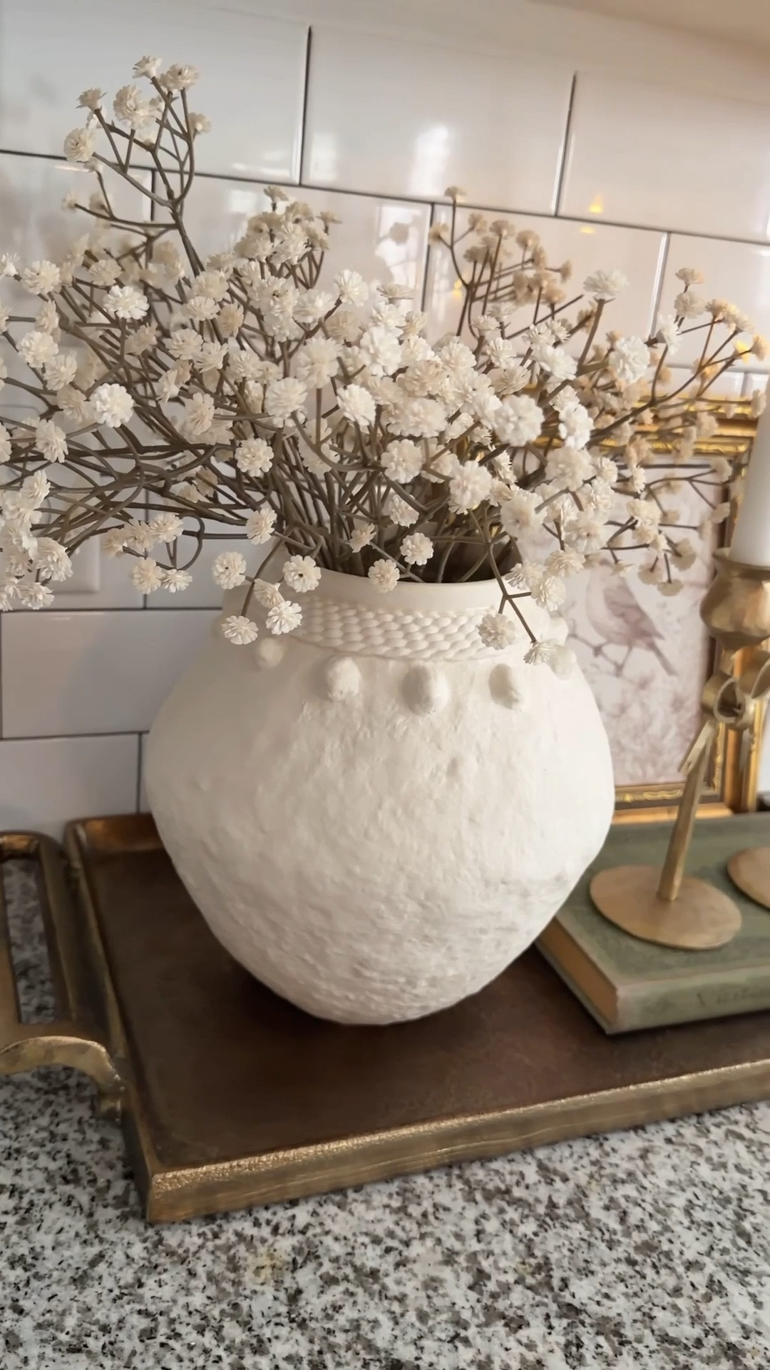 This little spot in my kitchen was feeling…empty. So I fixed it 🤎

I started with a brass tray, added a textured vase, and then the star of the show—this real touch baby’s breath (it sold out once already 👀). It’s THAT good, so don’t wait.

Finished it off with a book, a piece of art, and the prettiest bow candlesticks. Simple, but it completely changed the space.