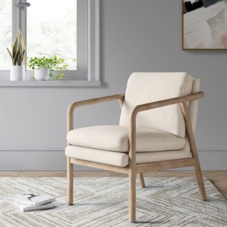 Sleek and stylish, this Tufeld Wood Arm Chair from Threshold™ lends a modern, minimalist vibe to any seating arrangement in your home. Crafted with a sturdy, open-style wood frame in light beige, this lightweight and compact accent chair offers cool, contemporary appeal to your space, while the high armrests and slightly angled back make for a snug and comfy seating experience. The double padding along the seat and back in soft gray upholstery invites you to sink back and relax. Pair with coordinating pieces for cohesive flair, or use as a solo accent piece to round off any seating area for a polished look.

#LTKFind #LTKsalealert #LTKhome